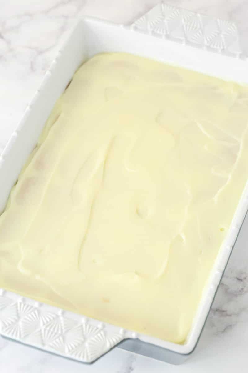 a layer of cheesecake pudding on top of the golden oreos in 9 x13 pan