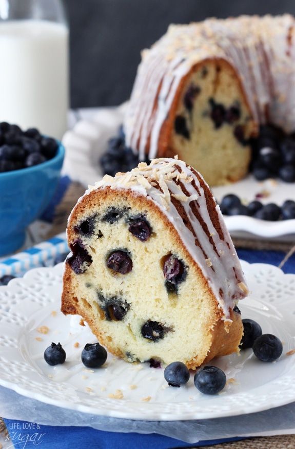 A slice of Blueberry Coconut Bundt Cake on a white plate