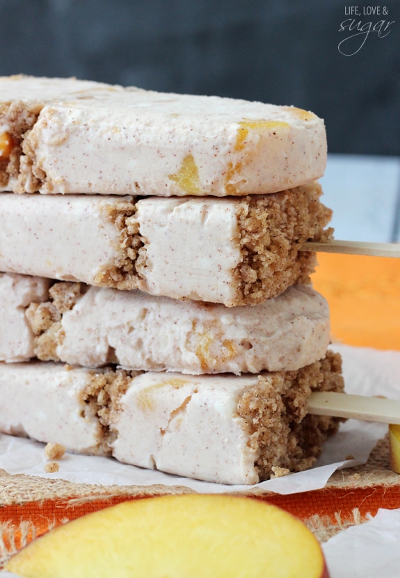 Four Peach Streusel Popsicles stacked on a table