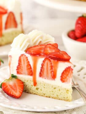 slice of strawberry shortcake cheesecake on white plate