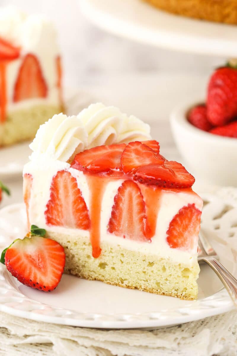 slice of strawberry shortcake cheesecake on white plate