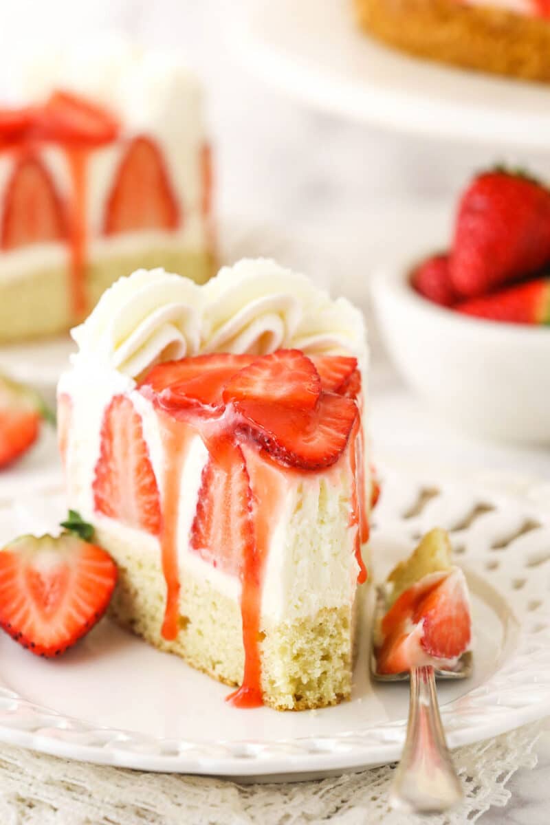 slice of strawberry shortcake cheesecake with a bite taken
