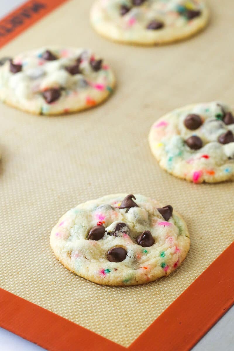 Freshly baked cake batter chocolate chip cookies on a baking sheet