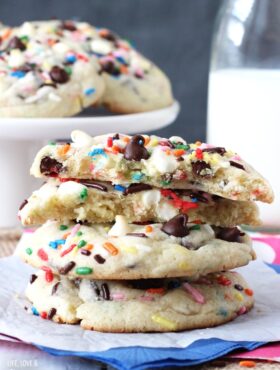 Funfetti Cake Batter Chocolate Chip Cookies stacked and one cookie halved