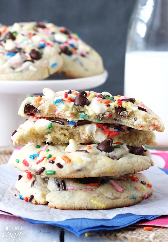 Funfetti Cake Batter Chocolate Chip Cookies in a stack with one broken in half