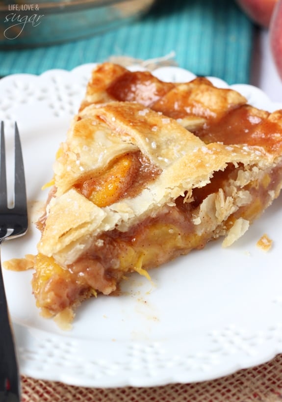 Close up of a slice of pie with peaches in the middle