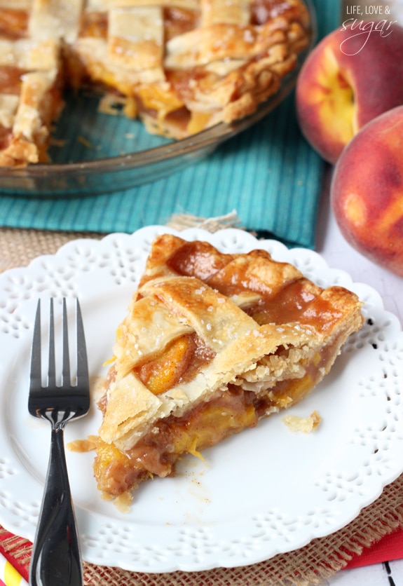 A fresh slice of Peach Pie on a plate with a fork