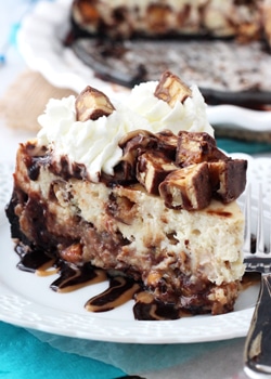 Snickers Cheesecake slice on white plate