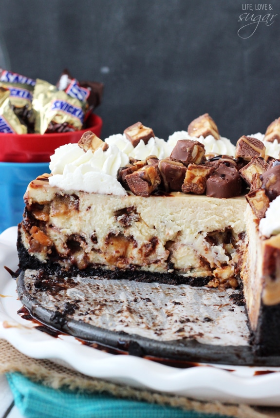 Snickers Cheesecake with a couple slices removed