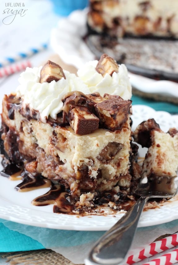 Snickers Cheesecake slice on a white plate