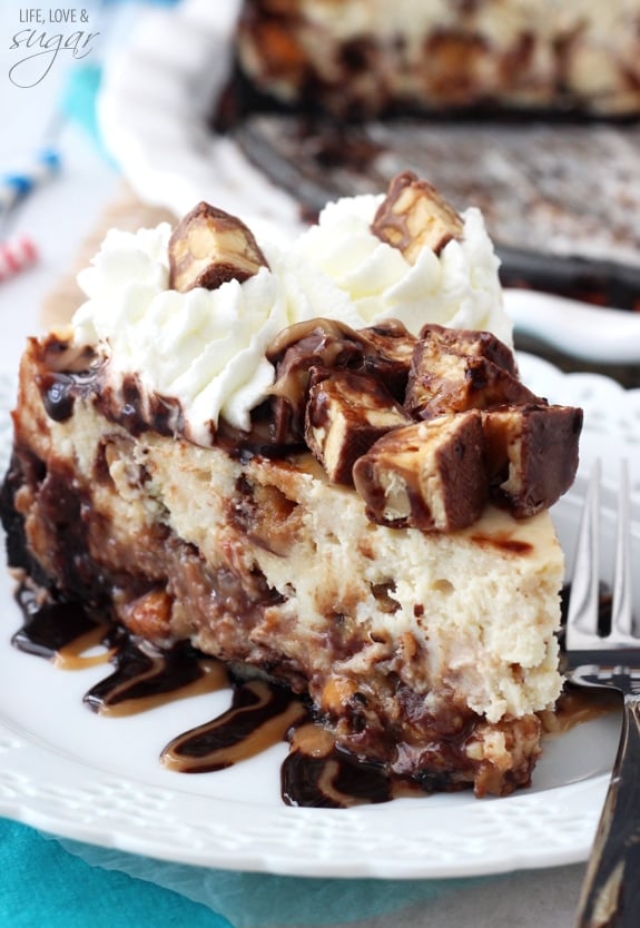 Snickers Cheesecake slice on a white plate