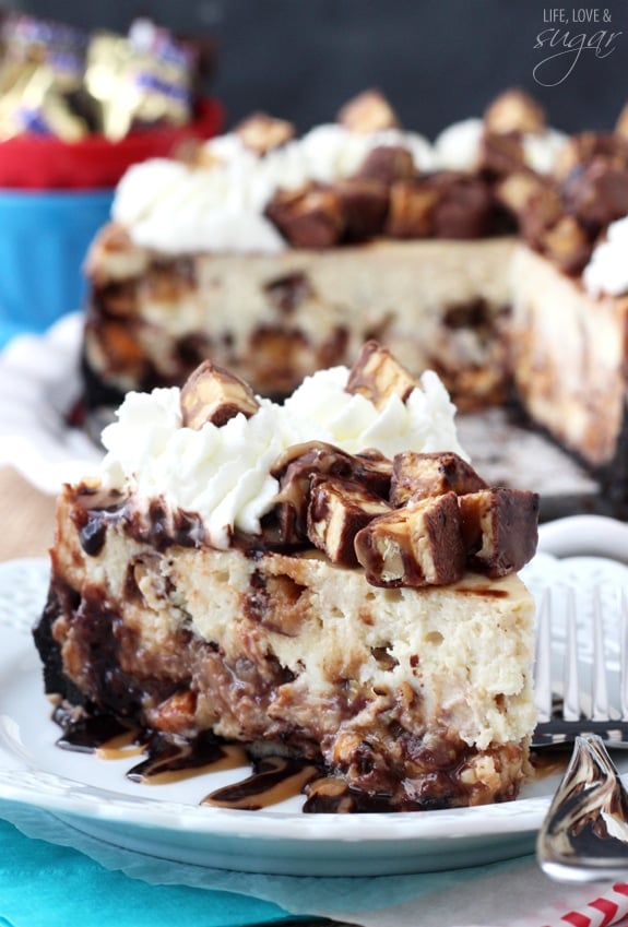 Snickers Cheesecake slice on a white plate