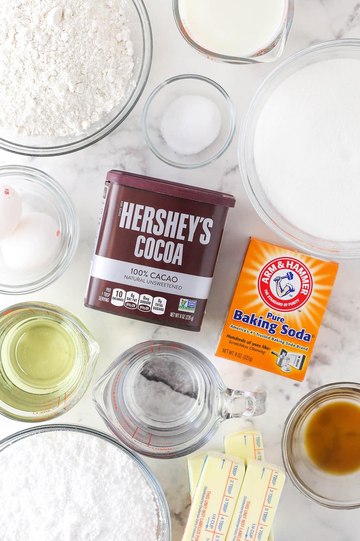 Ingredients for a homemade chocolate cake on a marble counter