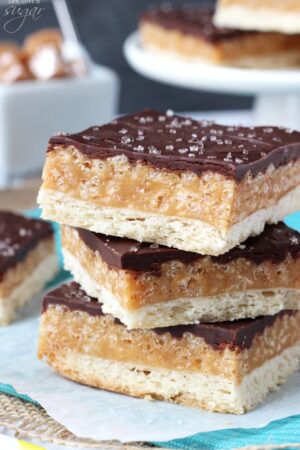 A Close-Up Shot of Three Stacked Chocolate Caramel Cookie Bars Topped with Sea Salt