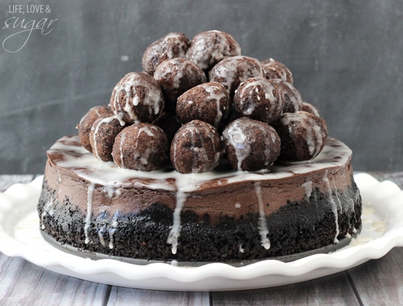 An Over-The-Top Chocolate Donut Hole Cheesecake on a Serving Platter