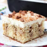 Cinnamon Roll Poke Cake on white plate