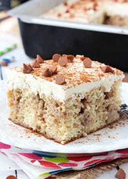 Cinnamon Roll Poke Cake on white plate