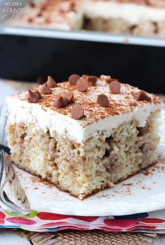 A Piece of Cinnamon Roll Poke Cake on a White Plate