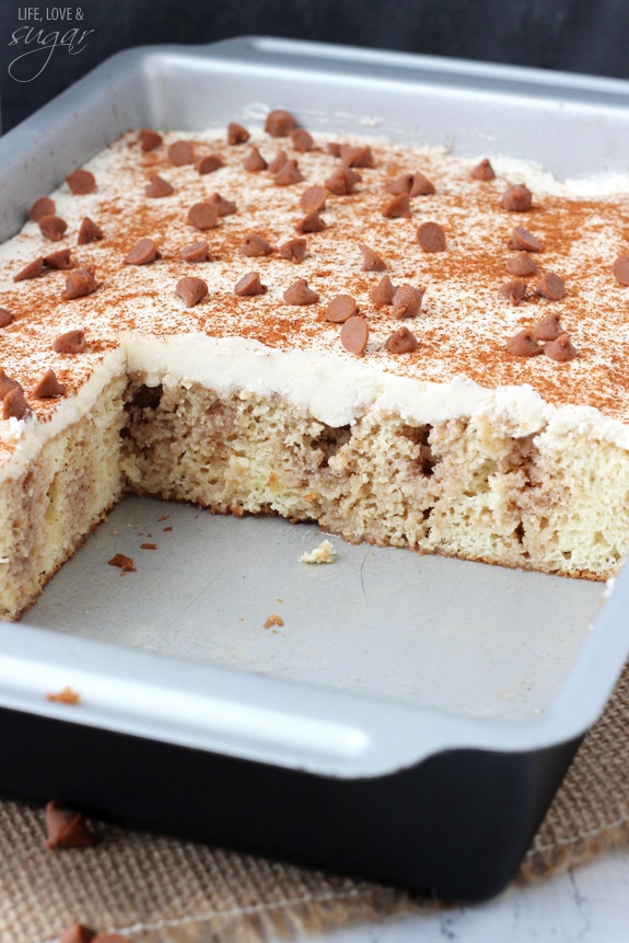 Cinnamon Roll Poke Cake in a rectangular pan with a few slices removed