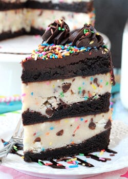 Funfetti Cake Batter Cookie Dough Brownie Layer Cake slice on white plate