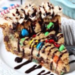Monster Cookie Cheesecake Pie slice on white plate