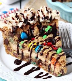 Monster Cookie Cheesecake Pie slice on white plate