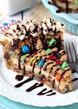 Monster Cookie Cheesecake Pie slice on white plate