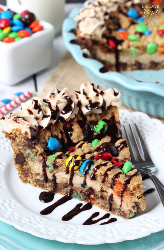 A slice of Monster Cookie Cheesecake Pie on a white plate