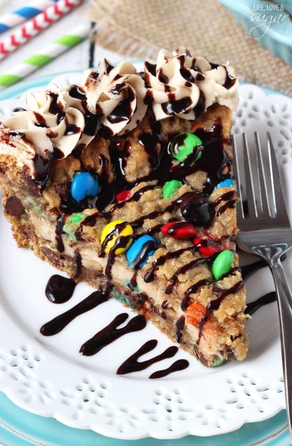 A slice of Monster Cookie Cheesecake Pie on a white plate