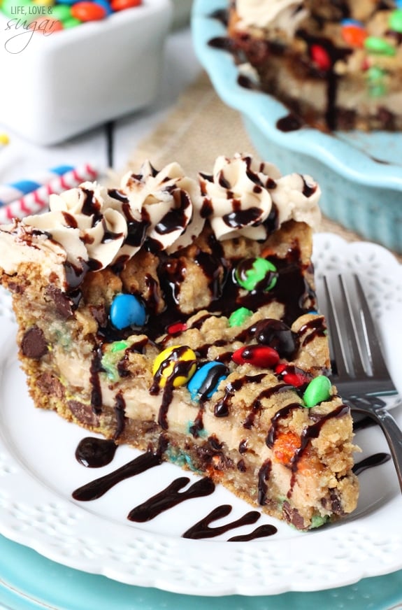 A slice of Monster Cookie Cheesecake Pie on a white plate