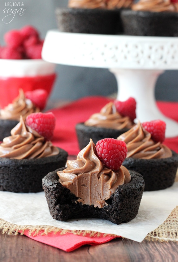 Nutella Cheesecake Chocolate Cookie Cups with a bite out of one