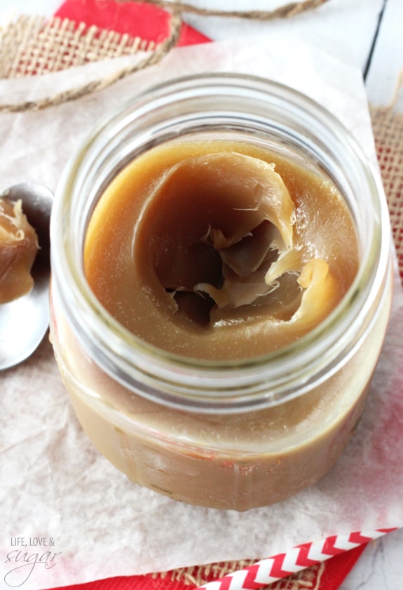 Overhead view of a mason jar of thickened caramel sauce