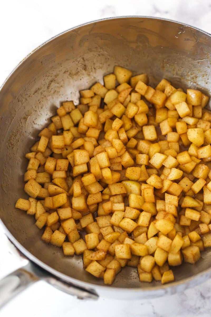cooked cinnamon apples in a silver pan