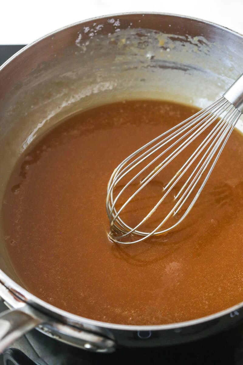 cooked caramel sauce in silver saucepan