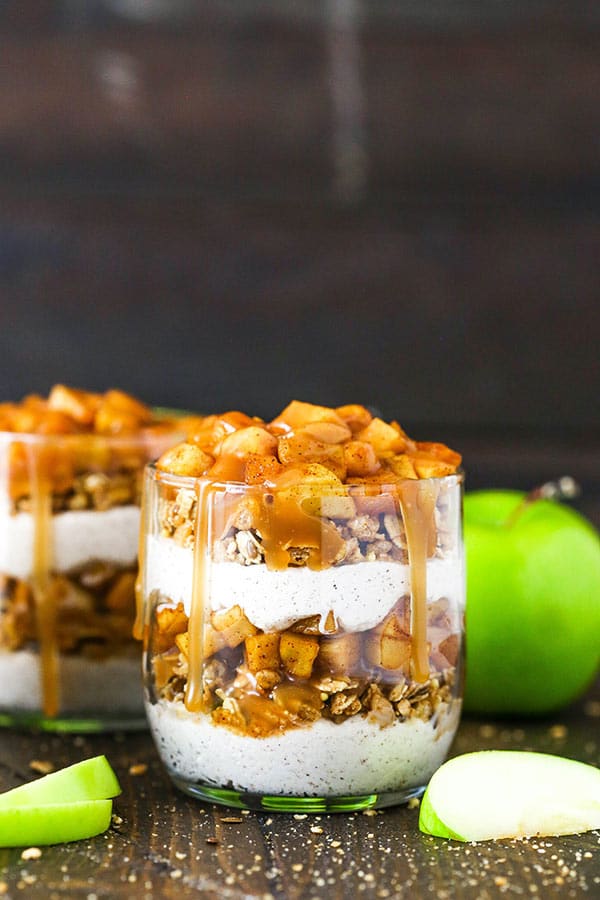side close up of caramel apple trifle with some sliced apples around it