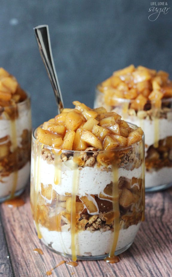 Caramel Apple Trifles - layers of granola, cinnamon whipped cream, cinnamon apples and caramel in a glass