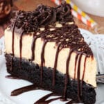 Pumpkin Chocolate Brownie Cheesecake slice on white plate