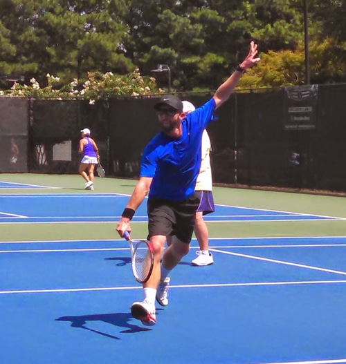 An Action Shot of Ian Playing Tennis