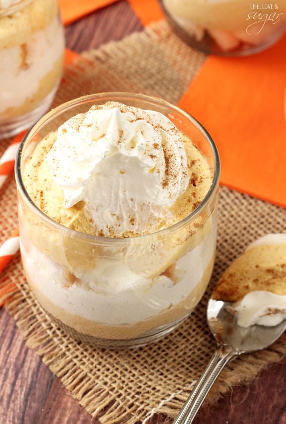 Overhead view of Mini Pumpkin Cheesecake Trifle in a glass with a bite on a spoon