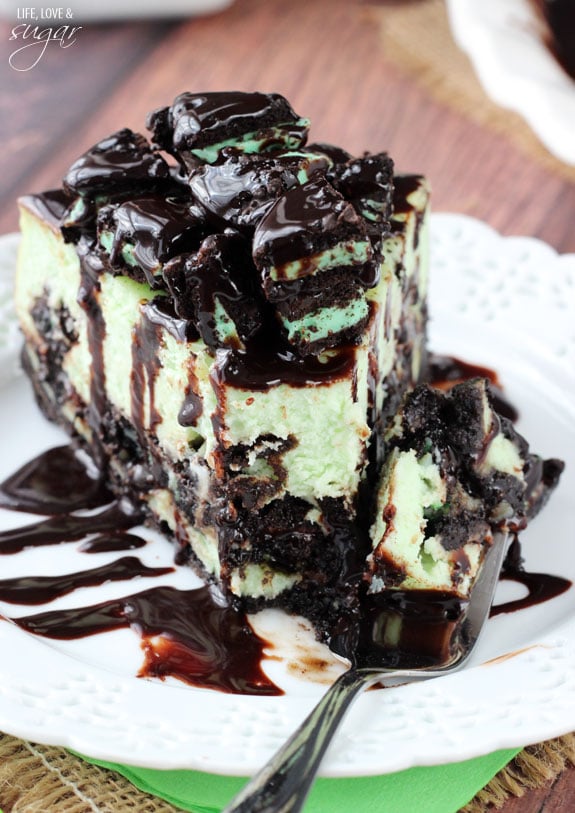 Mint Oreo Cheesecake slice on a plate with a bite on a fork