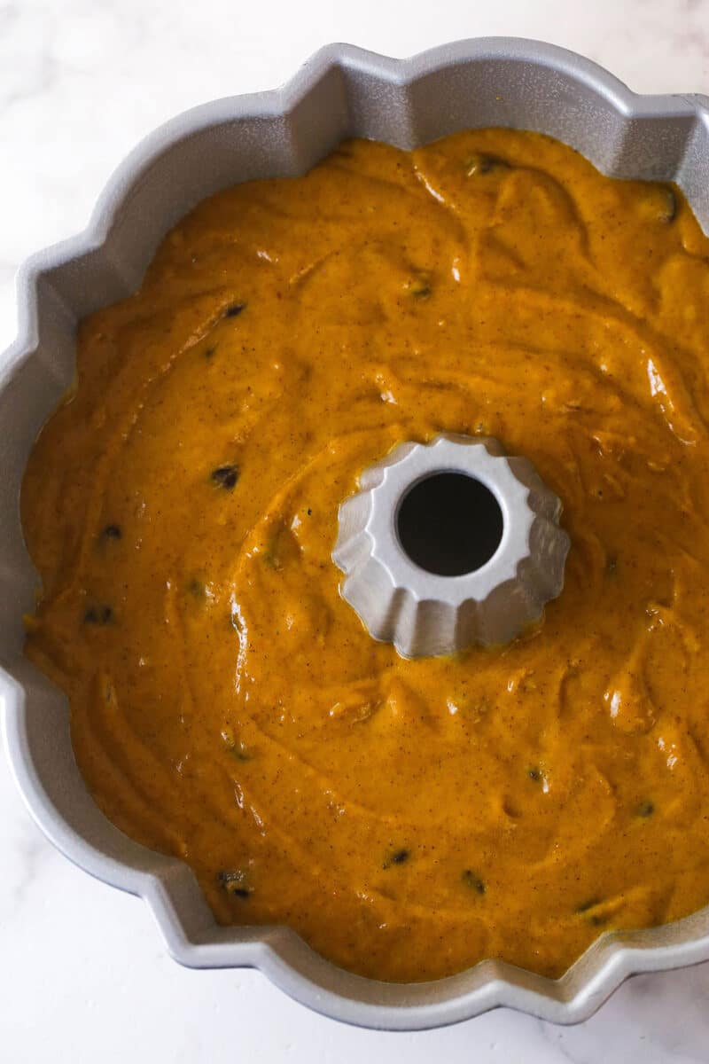 Every bite of this pumpkin chocolate chip bundt cake is moist, perfectly spiced, and dotted with chocolate chips. Pumpkin chocolate chip bundt cake batter in a pan