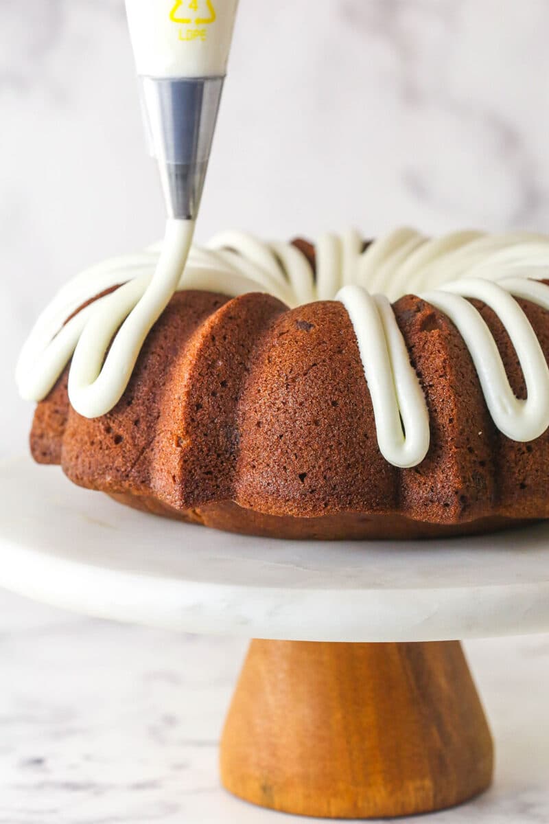 Every bite of this pumpkin chocolate chip bundt cake is moist, perfectly spiced, and dotted with chocolate chips. Piping cream cheese frosting over pumpkin chocolate chip bundt cake
