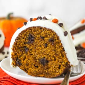 A slice of pumpkin chocolate chip bundt cake on a white plate