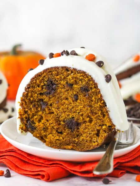 A slice of pumpkin chocolate chip bundt cake on a white plate