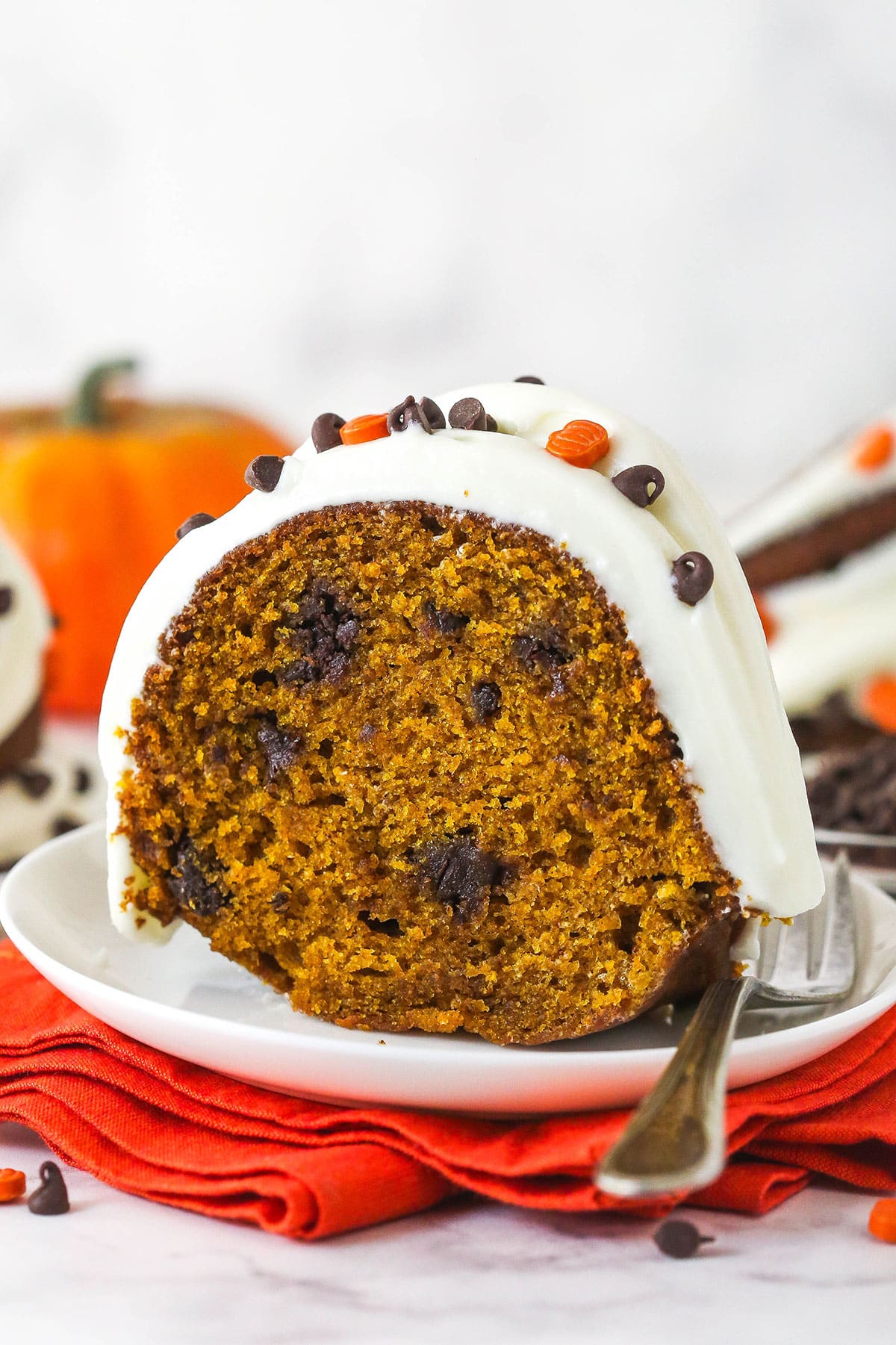 A slice of pumpkin chocolate chip bundt cake on a white plate