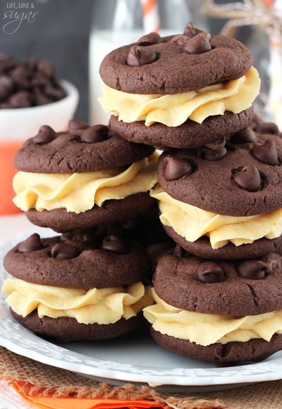 Pumpkin Chocolate Chip Cookie Sandwiches stacked on a white plate