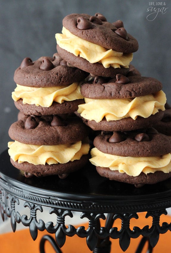 5 Pumpkin Chocolate Chip Cookie Sandwiches stacked on a black cake stand