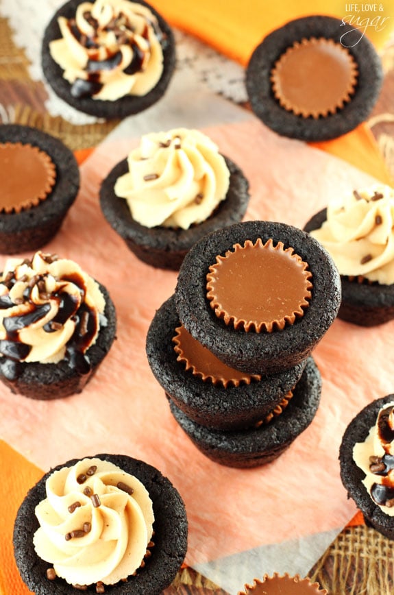 Top view of many Chocolate Cookie Cups with Reese's cups and peanut butter frosting 