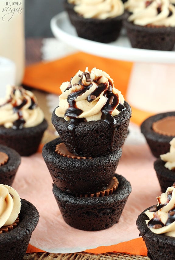 Three Chocolate Cookie Cups stuffed with Reese's and stacked on a table 