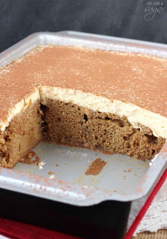 Tiramisu Poke Cake in pan with servings missing